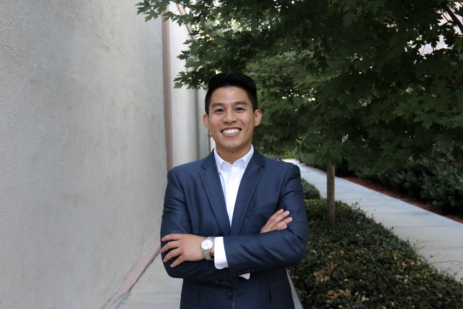 Jim Ngyuen standing with arms crossed and smiling